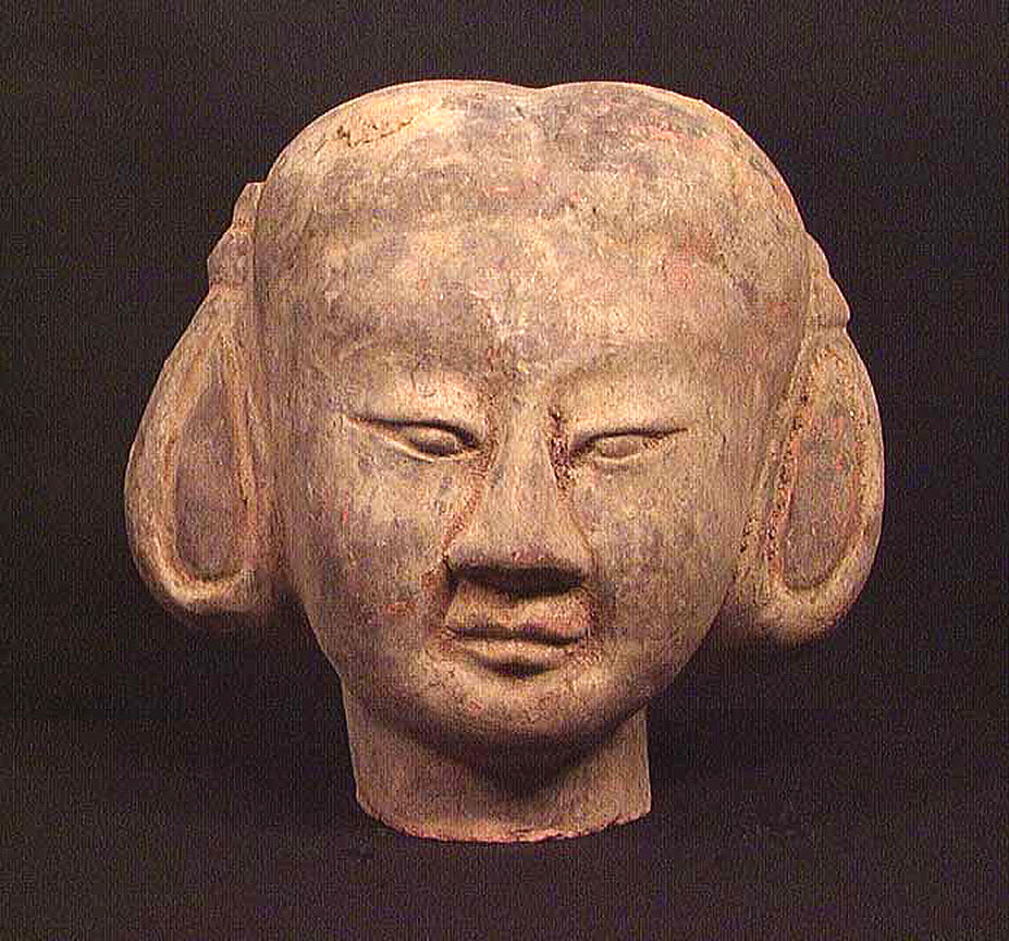 Large earthenware head with ornate hairstyle painted with dark violet 
